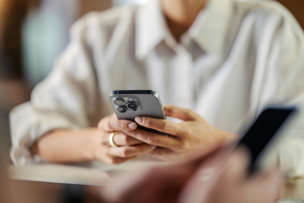 A traveler using his phone after learning the differences between eSIM and SIM cards in Japan